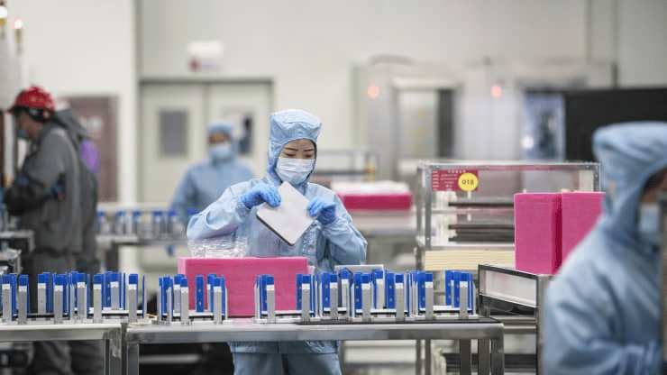 Employees manufacture photovoltaic cells on the production line at the Longi Green Energy Technology Co. plant in Xi'an, China, on July 21, 2020.