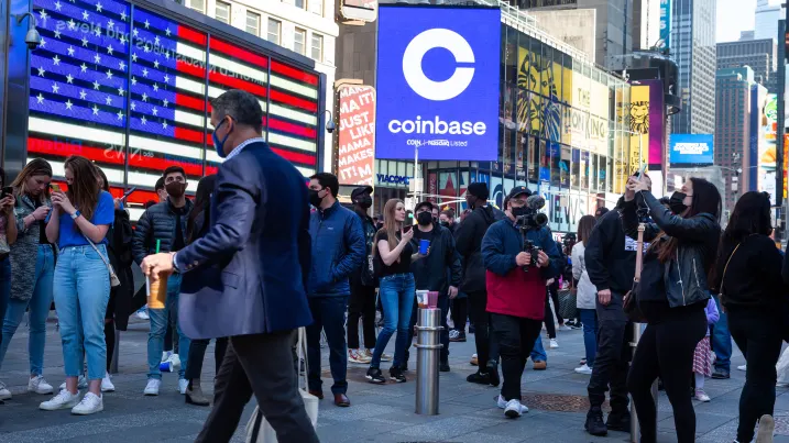 Monitors display Coinbase signage during the company's initial public offering (IPO) at the Nasdaq MarketSite in New York, U.S., on Wednesday, April 14, 2021.
